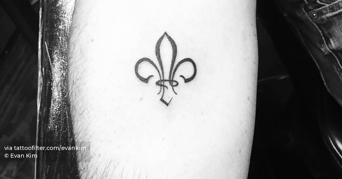 Minimalistic style fleur de lis tattoo located on the