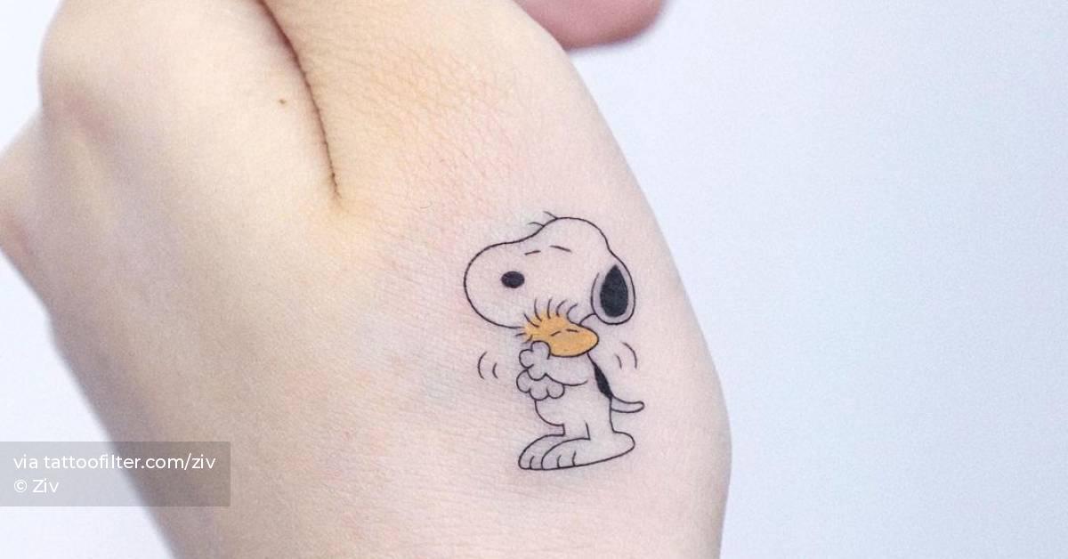 Snoopy and woodstock tattoo located on the hand.