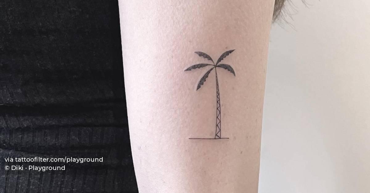 Minimalistic style palm tree tattoo located on the