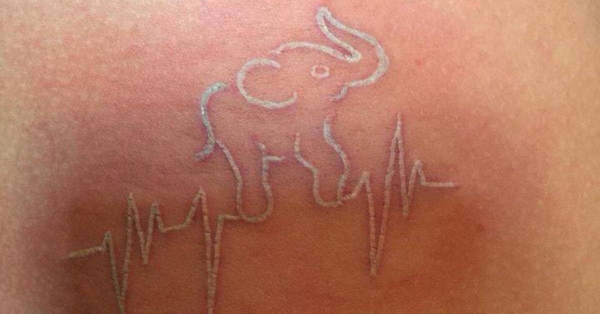 Elephant Rib Tattoo White ink elephant heartbeat tattoo on the ribs: