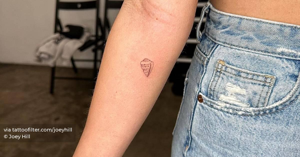 SIngle needle shell tattoo located on the inner