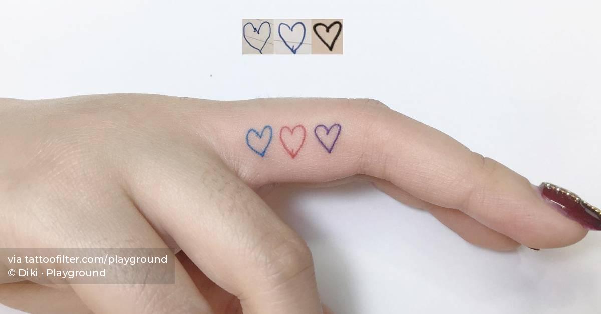 Tiny hearts tattoo located on the finger.
