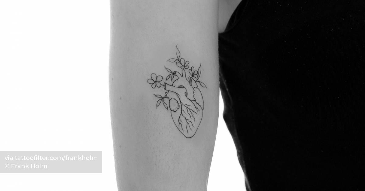 Fine line anatomical heart and flowers tattoo located