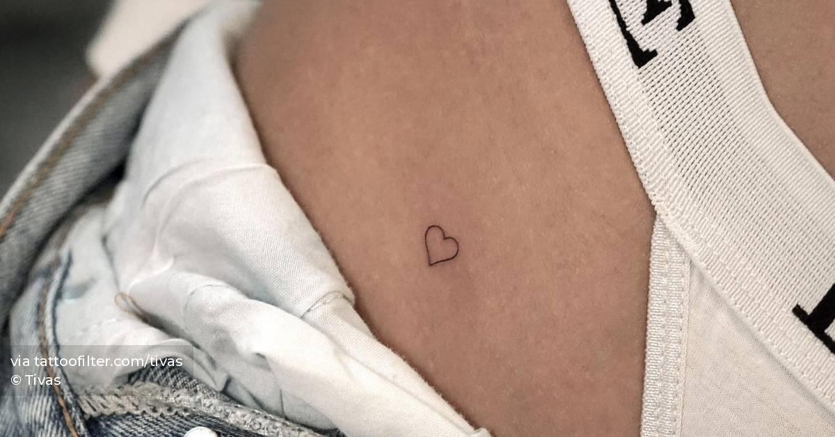Tiny minimalistic heart tattoo located on the pelvis.