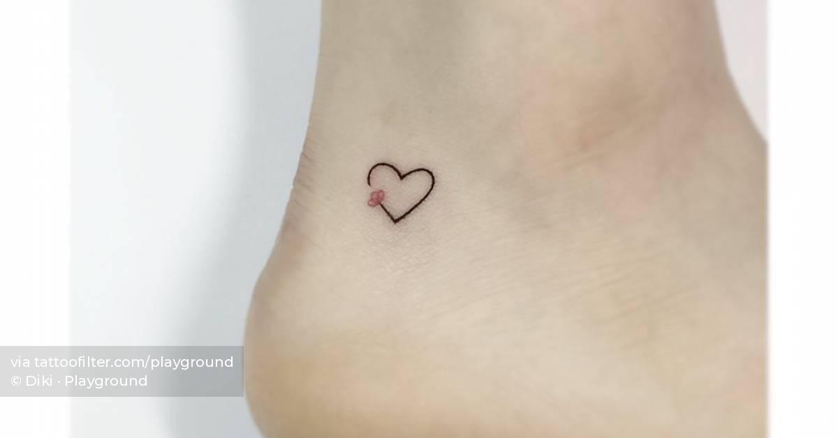 Minimalistic flower heart tattoo placed on the ankle.
