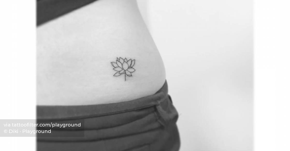 Tiny minimalistic lotus flower tattoo placed on the