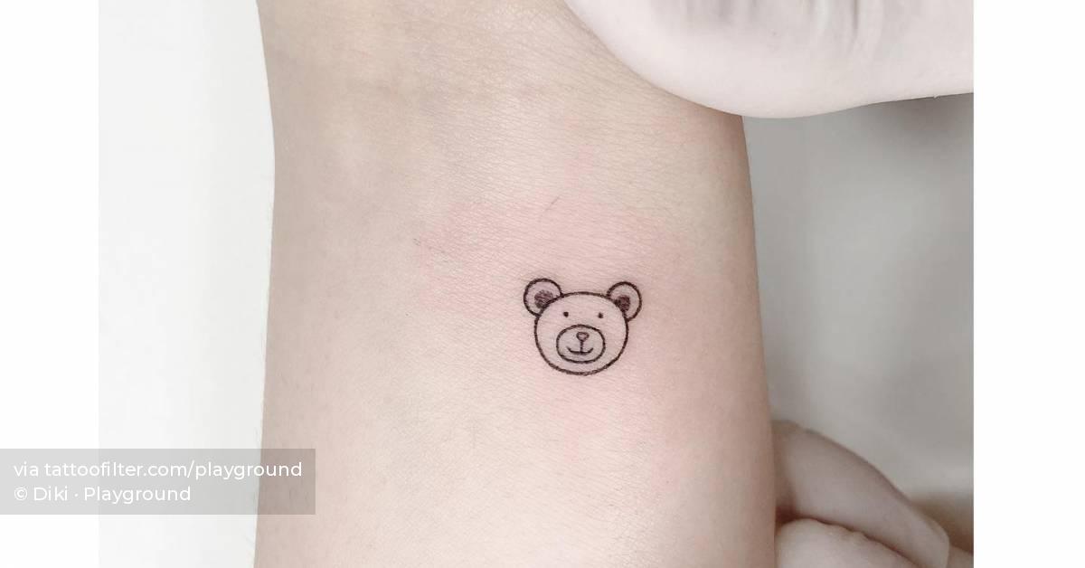 Minimalistic bear portrait tattoo placed on the wrist.