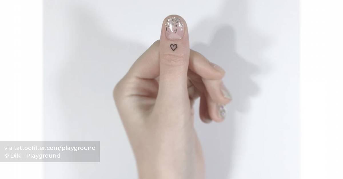 Tiny little heart tattoo located on the thumb.