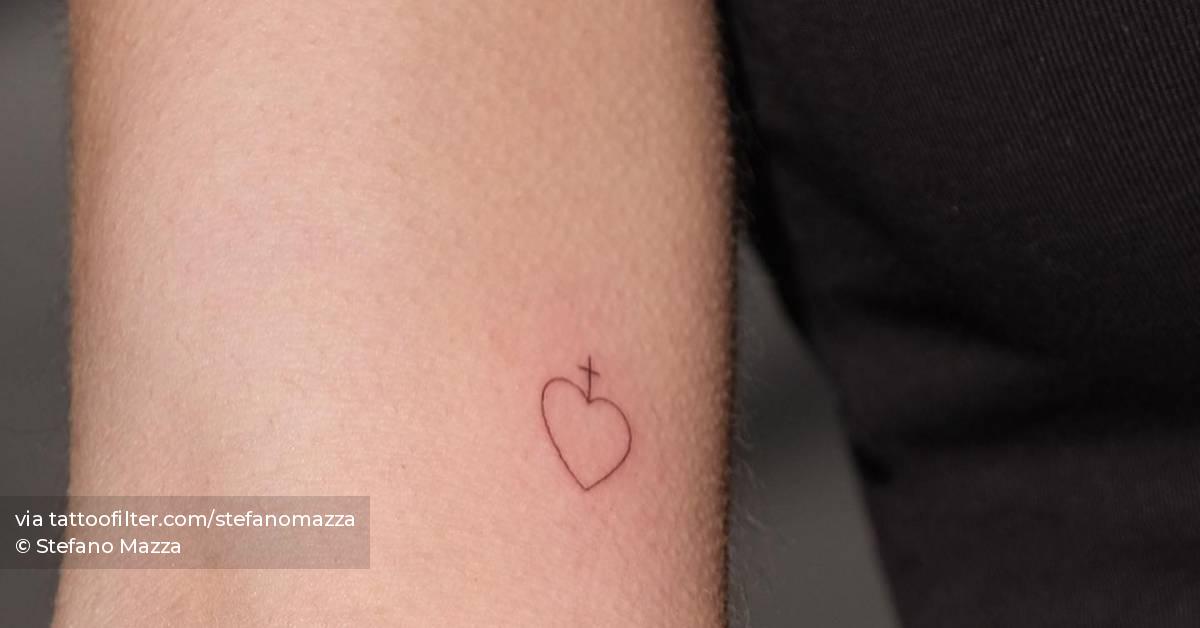 Minimalistic style cross and heart tattoo located on