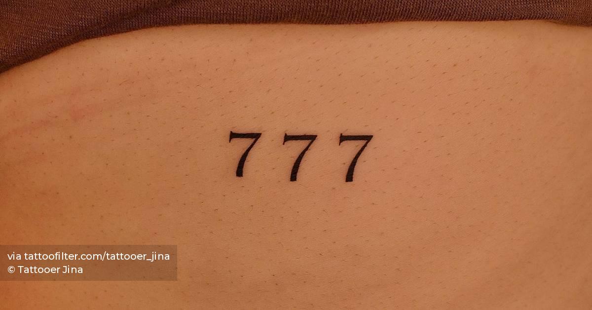 Angel number "777" tattooed on the rib.
