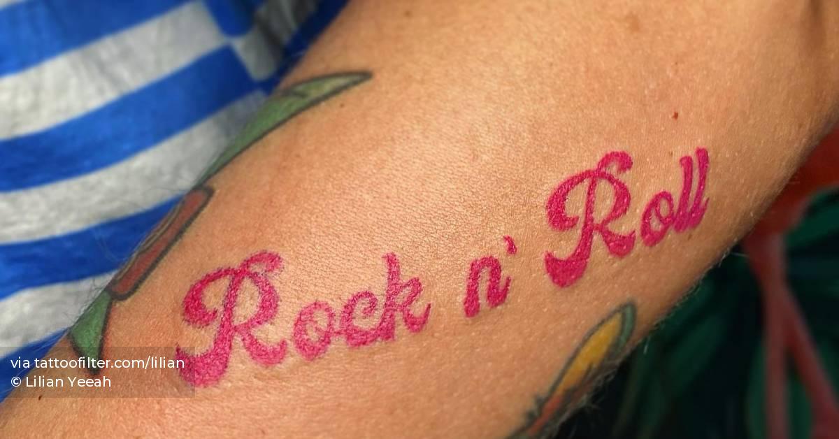 "Rock n' Roll" lettering tattoo located on the forearm.