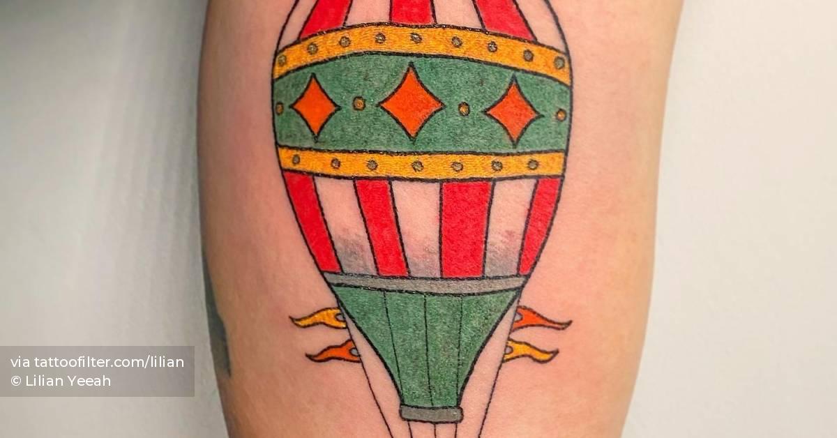 Hot air balloon tattoo hand poked on the inner arm.