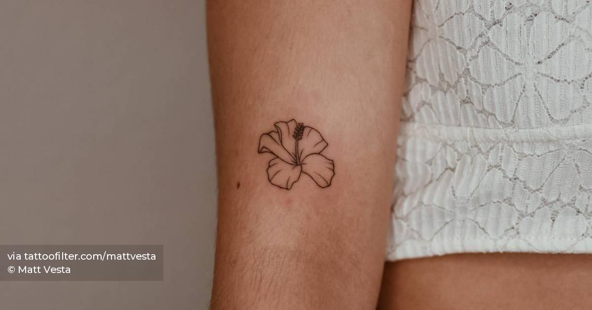 Minimalistic hibiscus flower tattoo done on the upper
