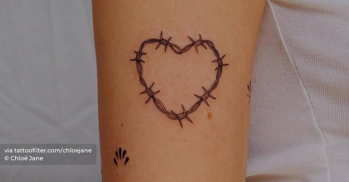 Barbed wire heart tattooed on the upper arm.