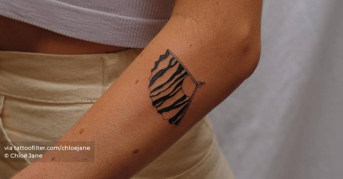 Hand fan tattoo located on the forearm, illustrative