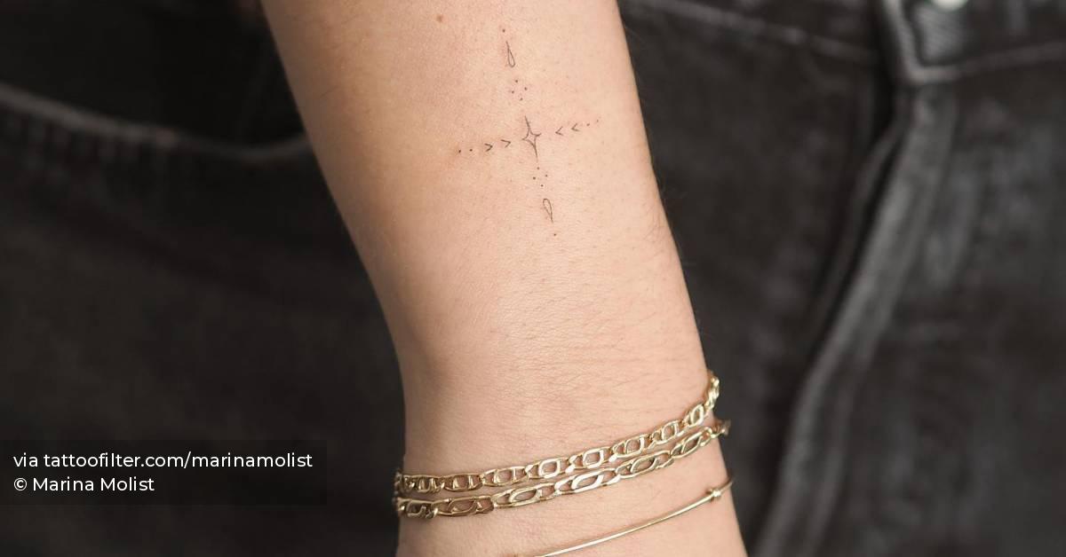 Fine line ornamental tattoo located on the wrist.