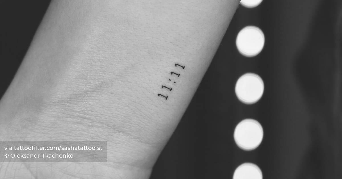 Tattoo of the angel number "11:11" located on the