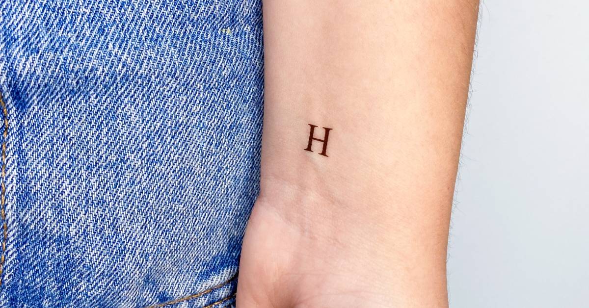 "H" serif capital letter temporary tattoo located on