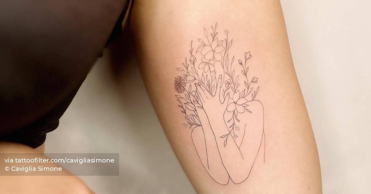 Fine line style flower head woman tattoo located on the