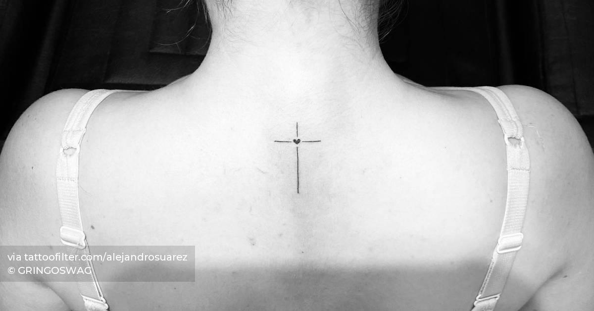 Cross and heart tattoo located on the upper back,