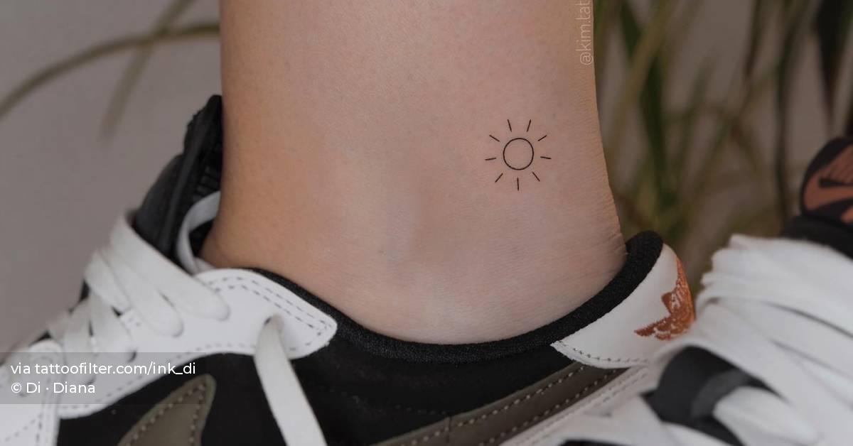 Tiny minimalistic sun tattoo located on the ankle.
