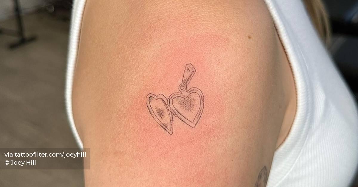 Single needle heart pendant tattoo located on the upper
