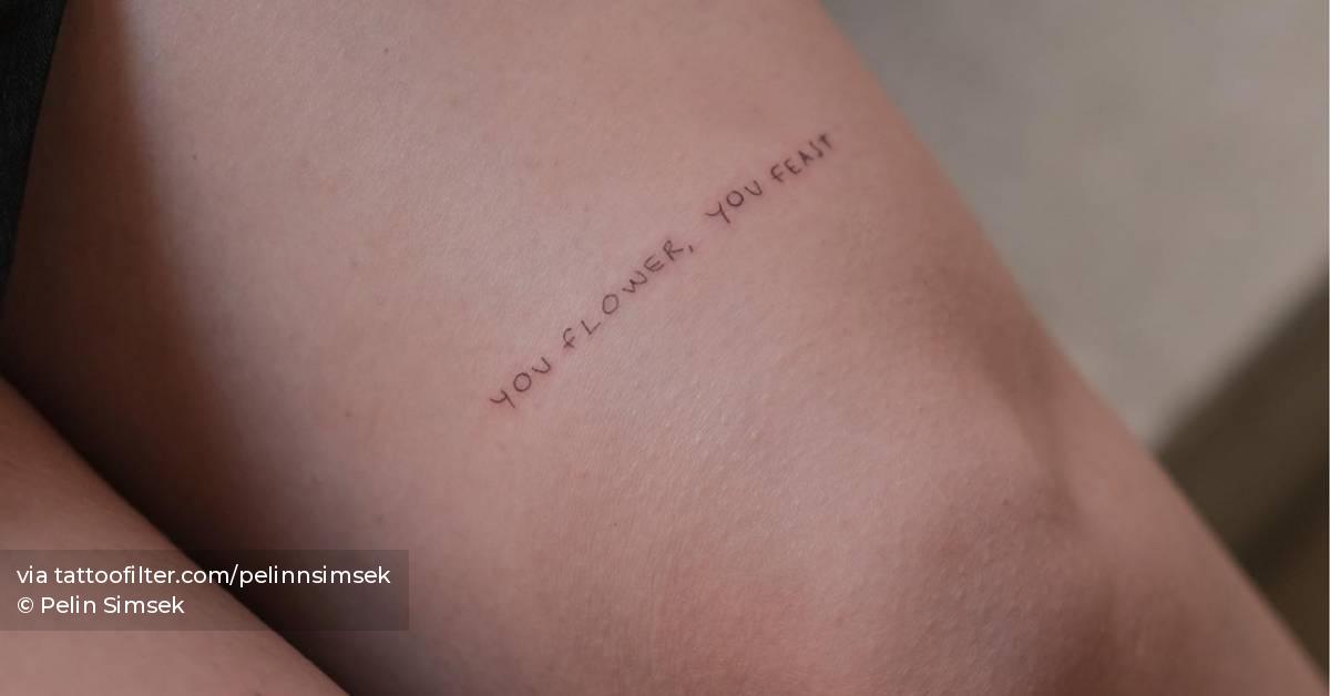 "You flower, you feast" lettering tattoo located on the