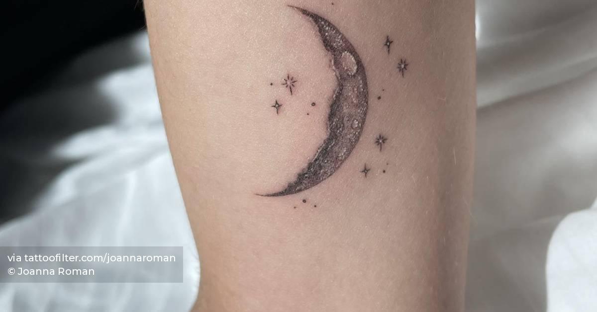 Illustrative style crescent moon tattoo located on the