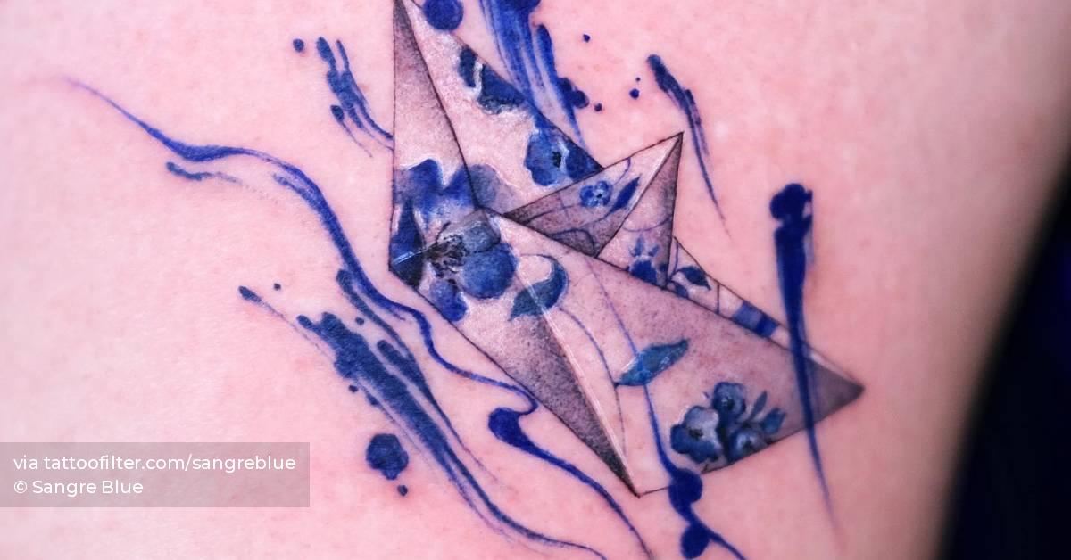 porcelain-paper-boat-tattoo-located-on-the-thigh