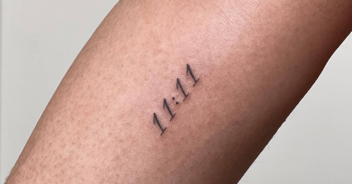 Angel number "11:11" tattoo located on the inner