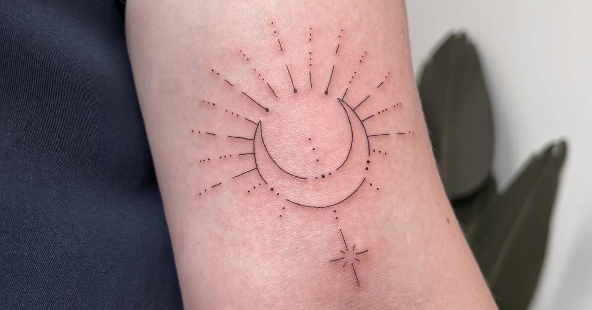 Fine line style sun and moon tattoo done on the bicep.