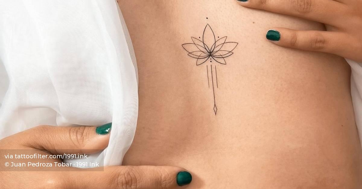 Fine line style lotus flower tattoo located on the