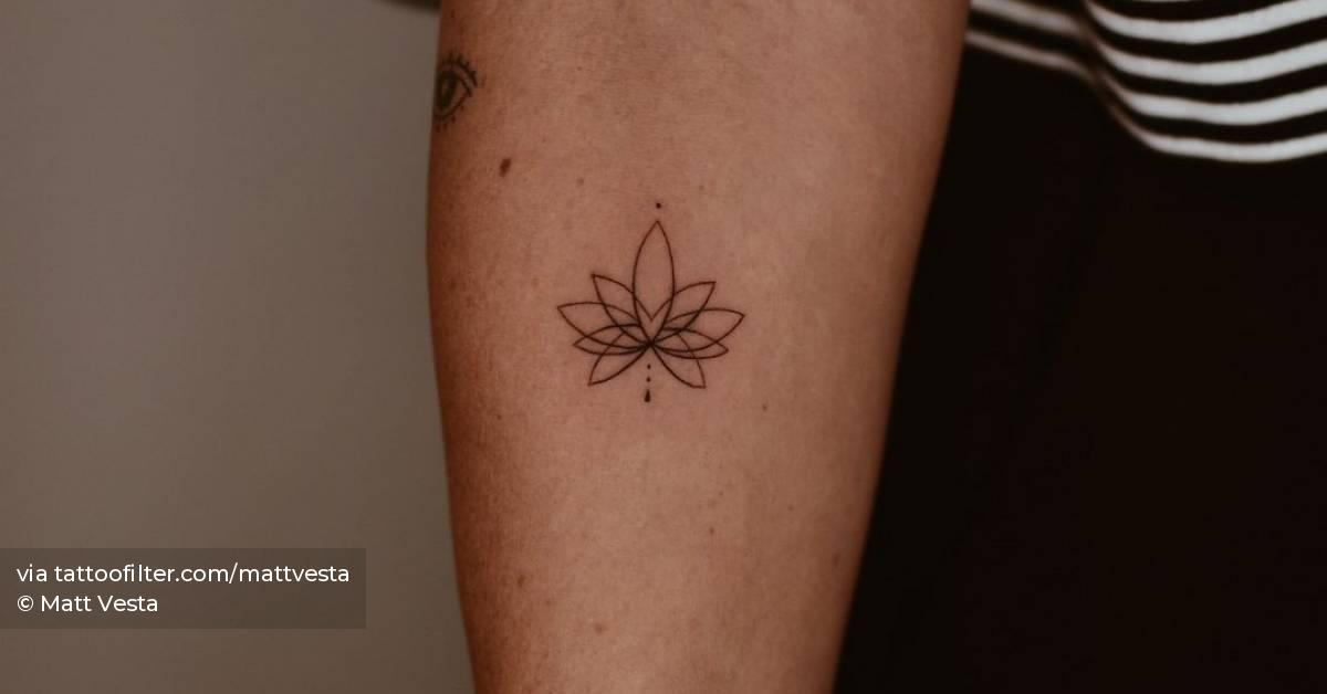 Fine line style lotus flower tattoo placed on the inner