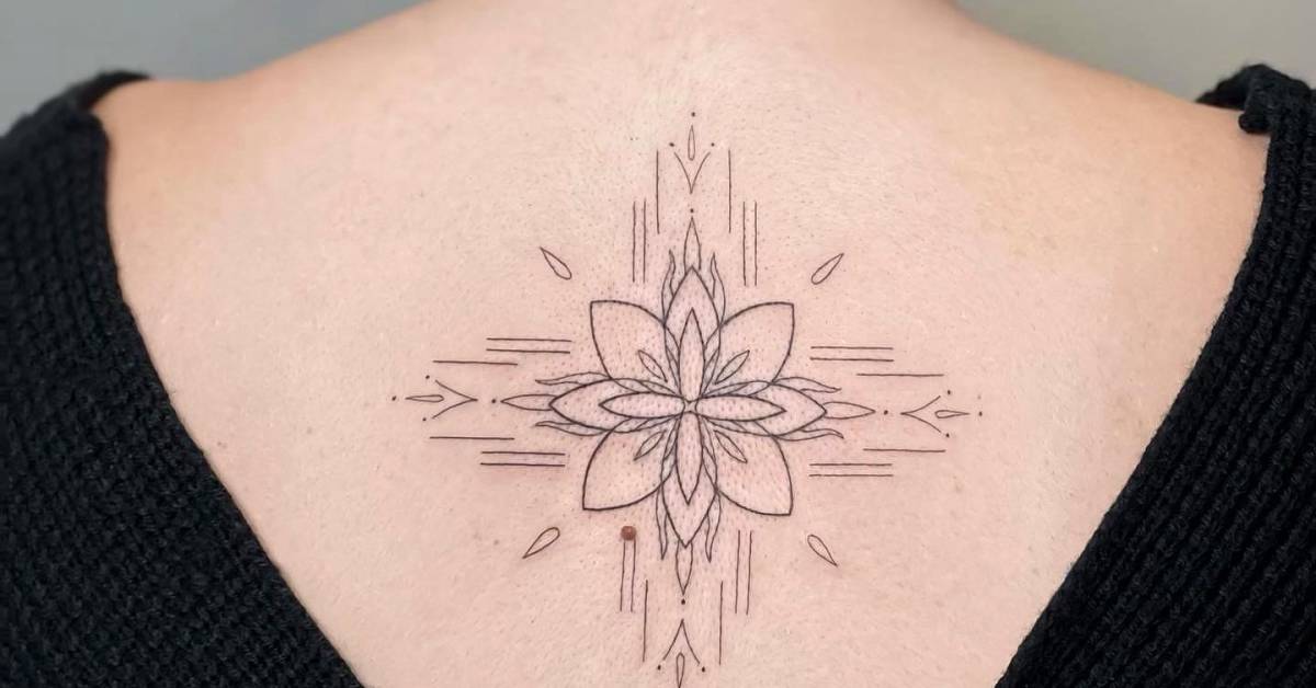 Fine line style ornamental tattoo placed on the upper