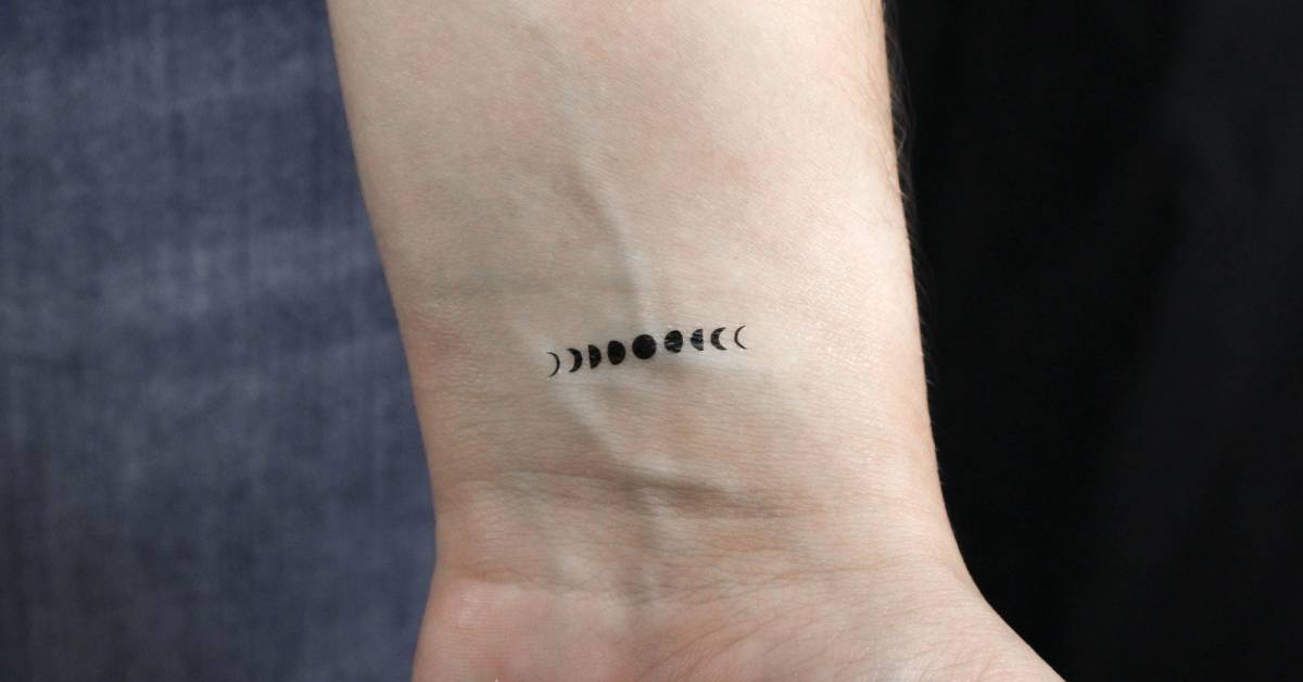 Minimalistic tiny moon phases temporary tattoo located