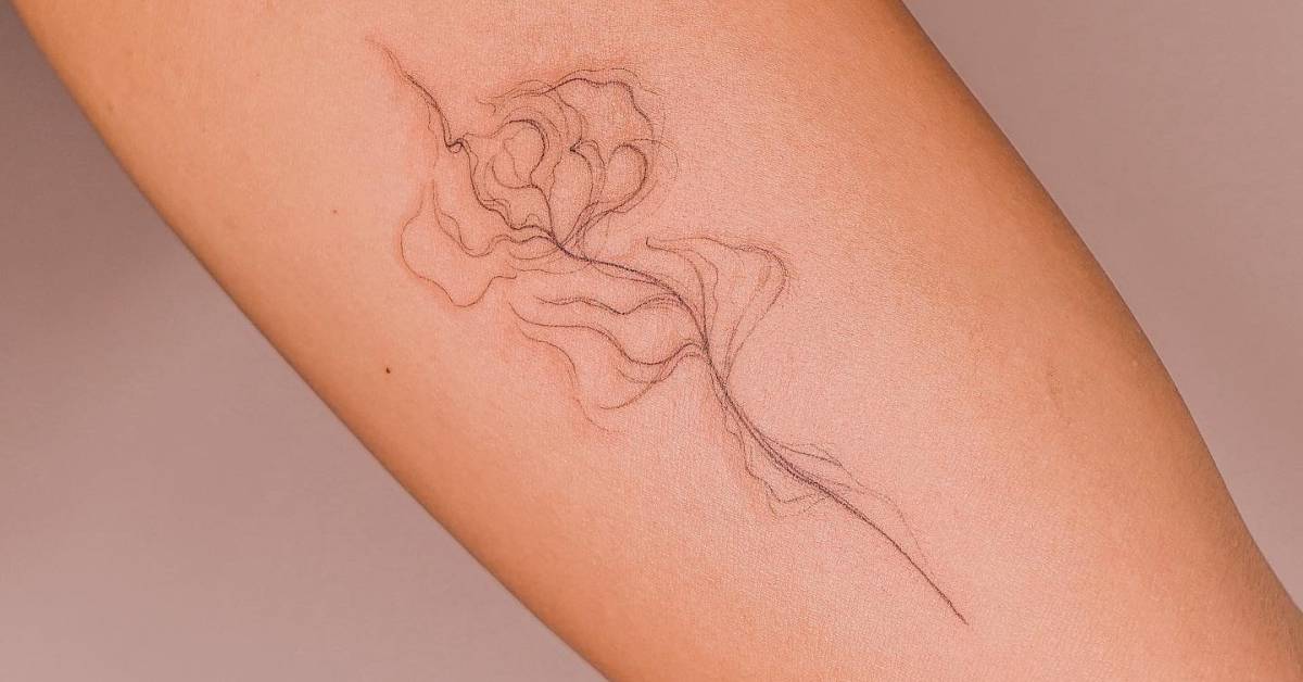 Abstract rose tattoo located on the inner arm.