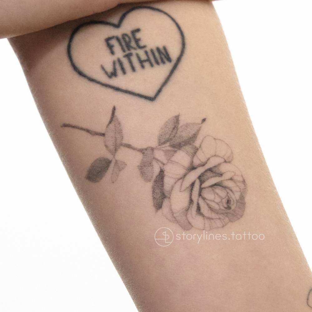 Healed single needle rose tattoo.