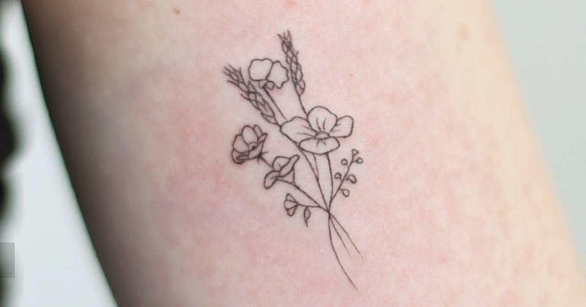 Fine line style flower bouquet tattoo placed on the