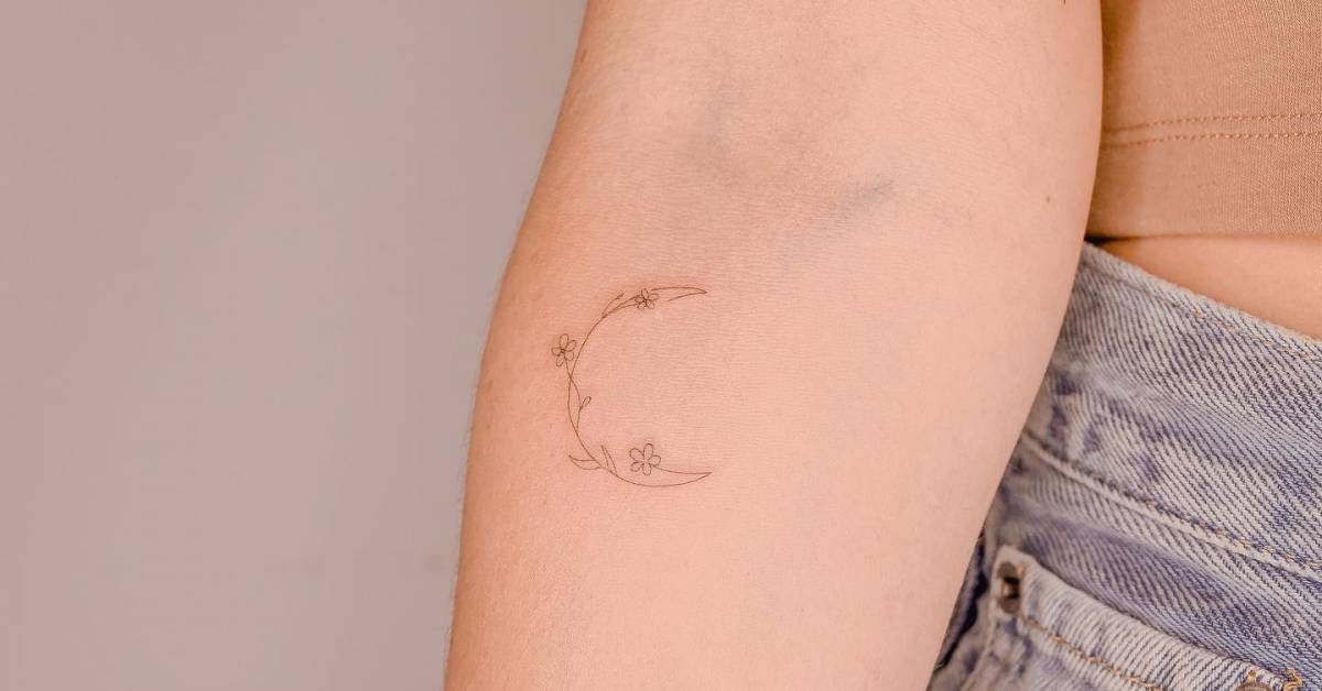Fine line style flower moon tattoo located on the inner