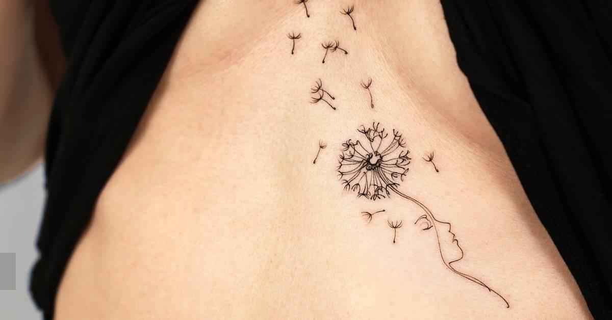 Fine line style flower head woman tattoo located on the