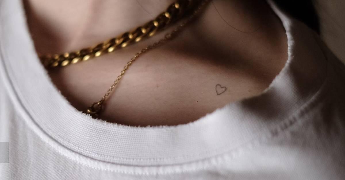 Tiny minimalistic heart tattoo placed on the