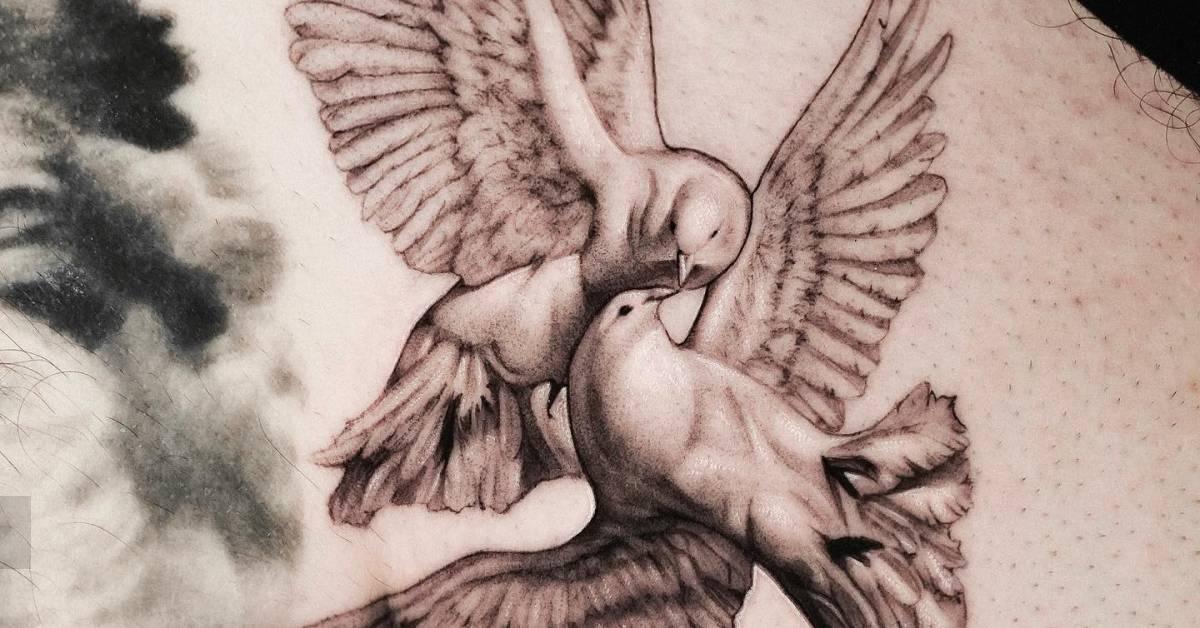 Black and grey doves kissing tattoo located on the