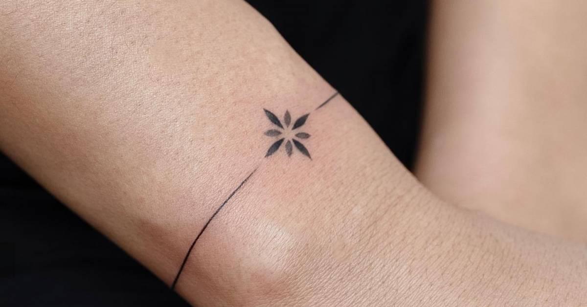 Minimalistic style ornamental wristband tattoo.