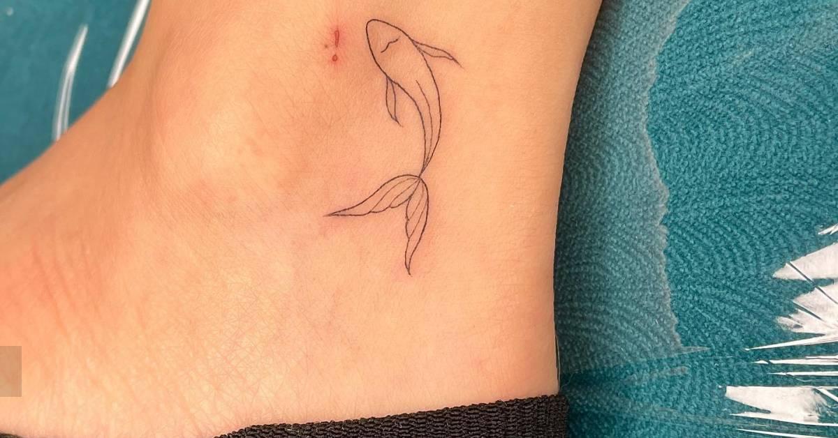 Fine line style koi fish tattoo located on the ankle.