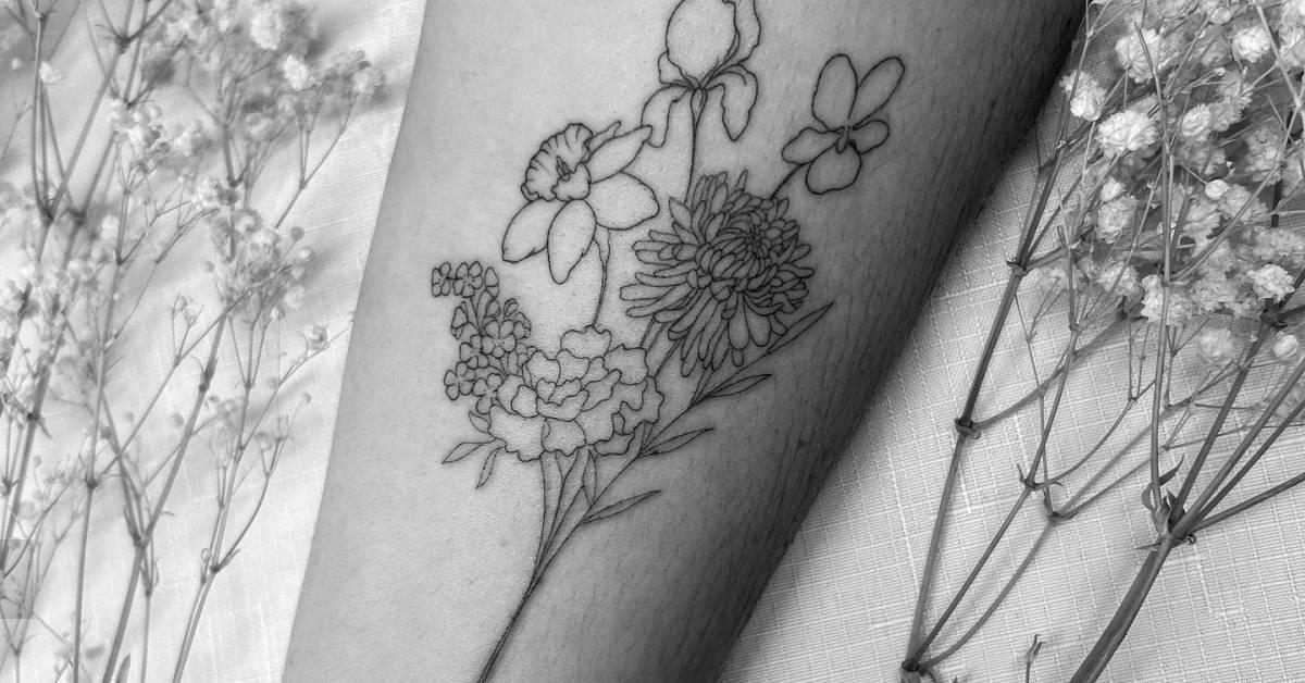 Fine line style flower bouquet tattoo located on the
