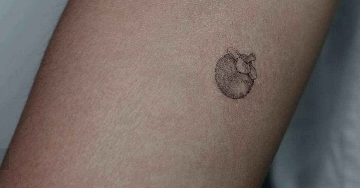 Single needle tiny mangosteen tattoo located on the