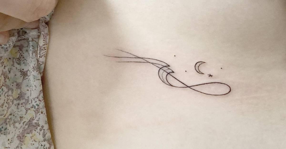 Fine line style wave and moon tattoo located on the