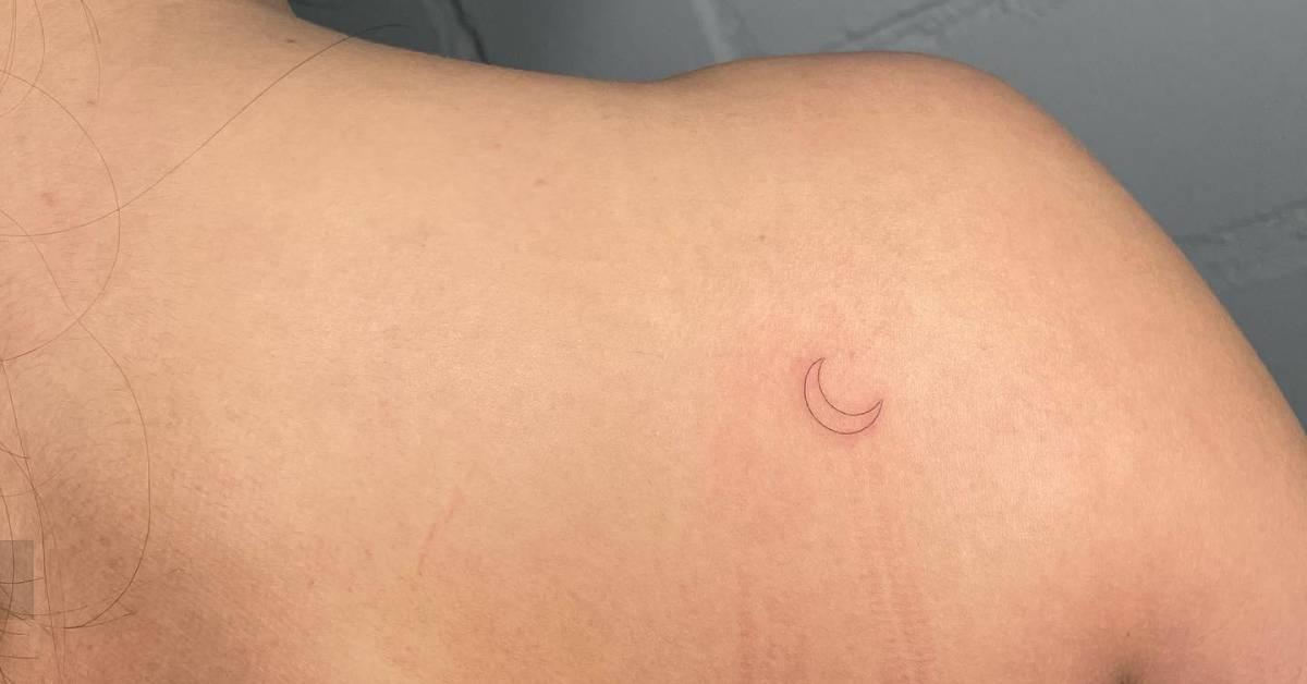Fine line style crescent moon tattoo done on the
