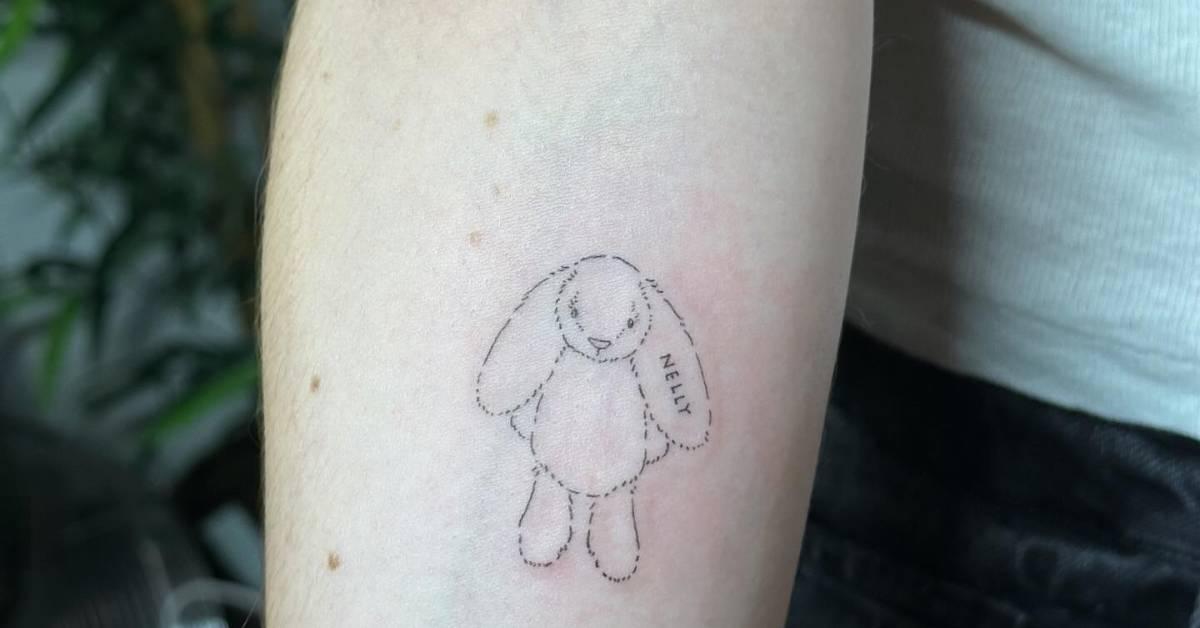Fine line style teddy bunny tattoo located on the inner