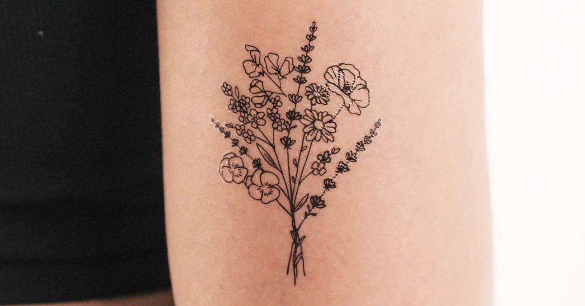 Fine line style flower bouquet tattoo located on the